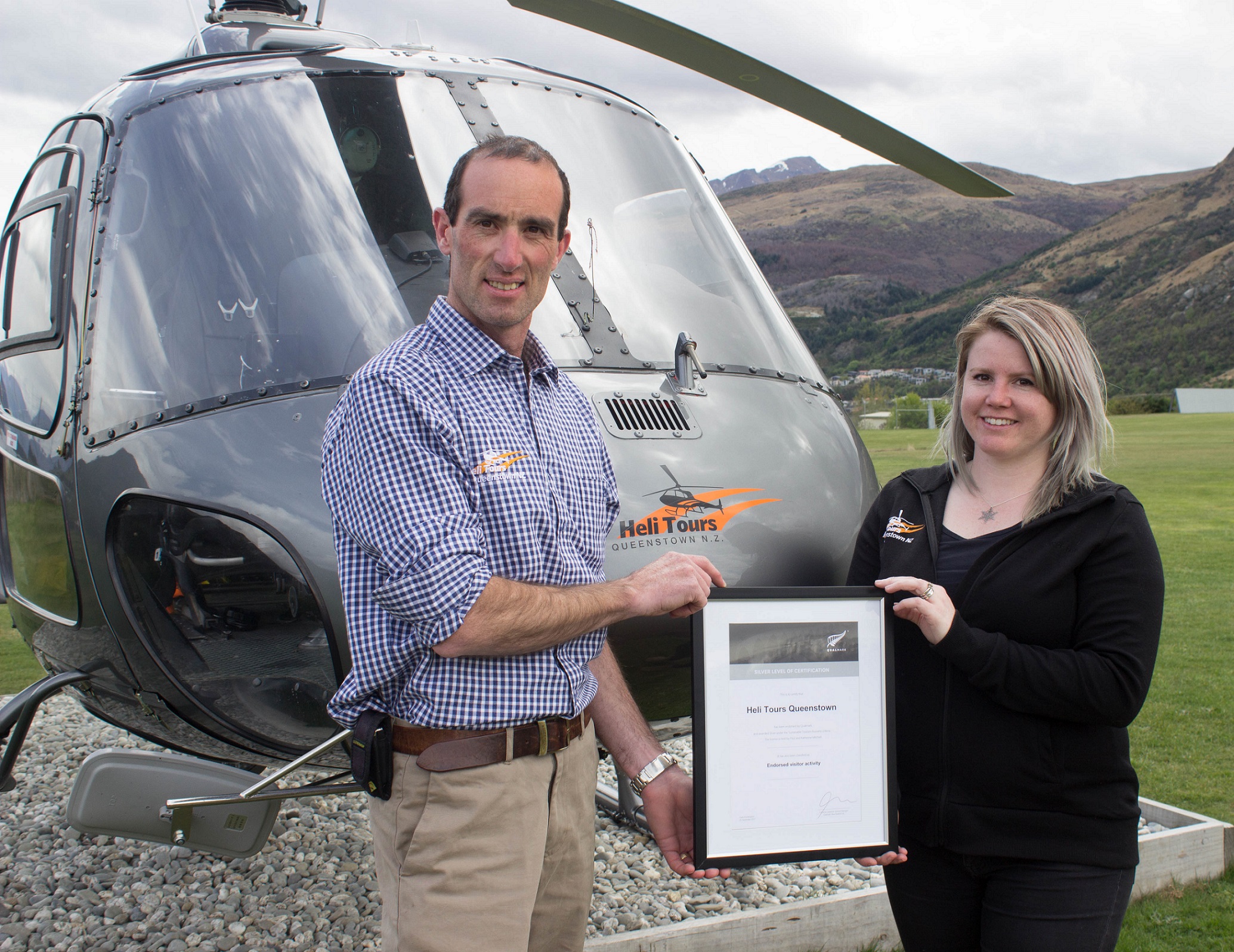 Heli Tours owner Paul Mitchell and Base Manager Jaime Flemming celebrate their Qualmark Silver award