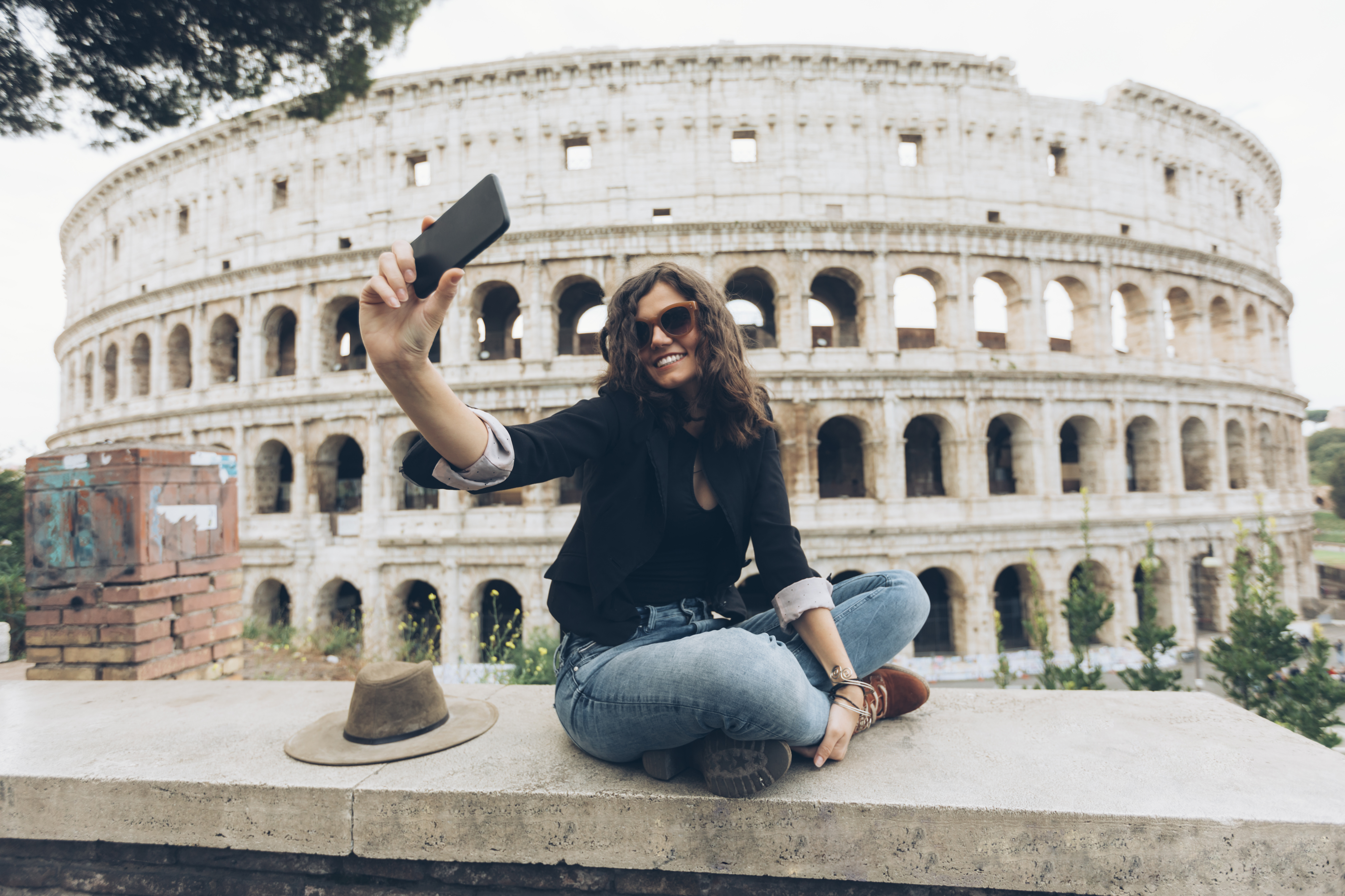 Young woman taking selfie in front of Coliseum